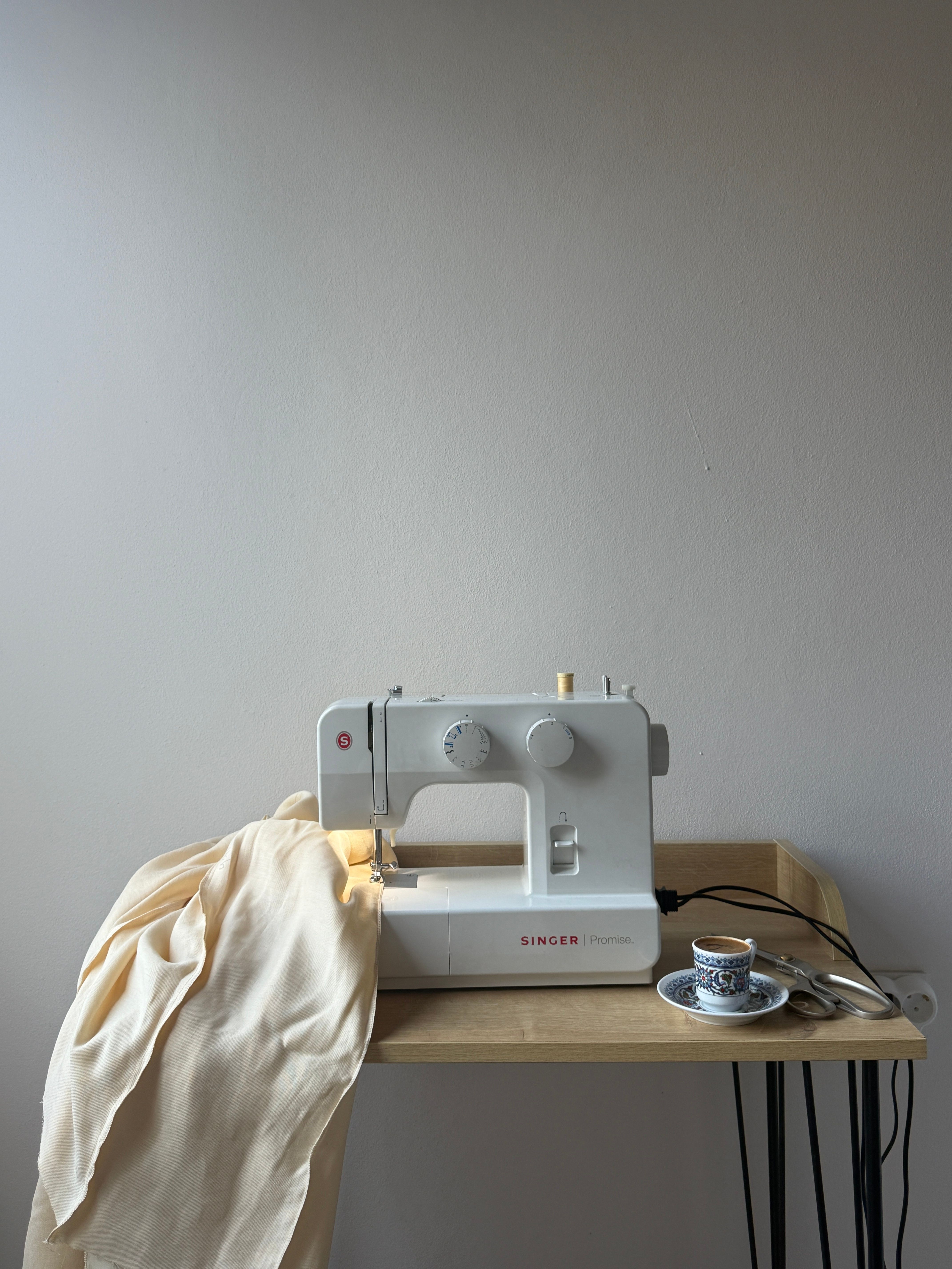 Minimalist Setup with Sewing Machine on Wooden Table · Free Stock Photo