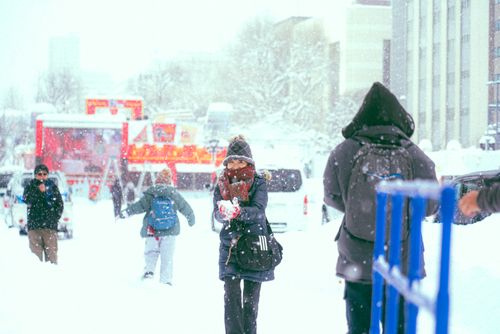Free A vibrant winter street scene in Japan featuring people enjoying a snowy day. Stock Photo