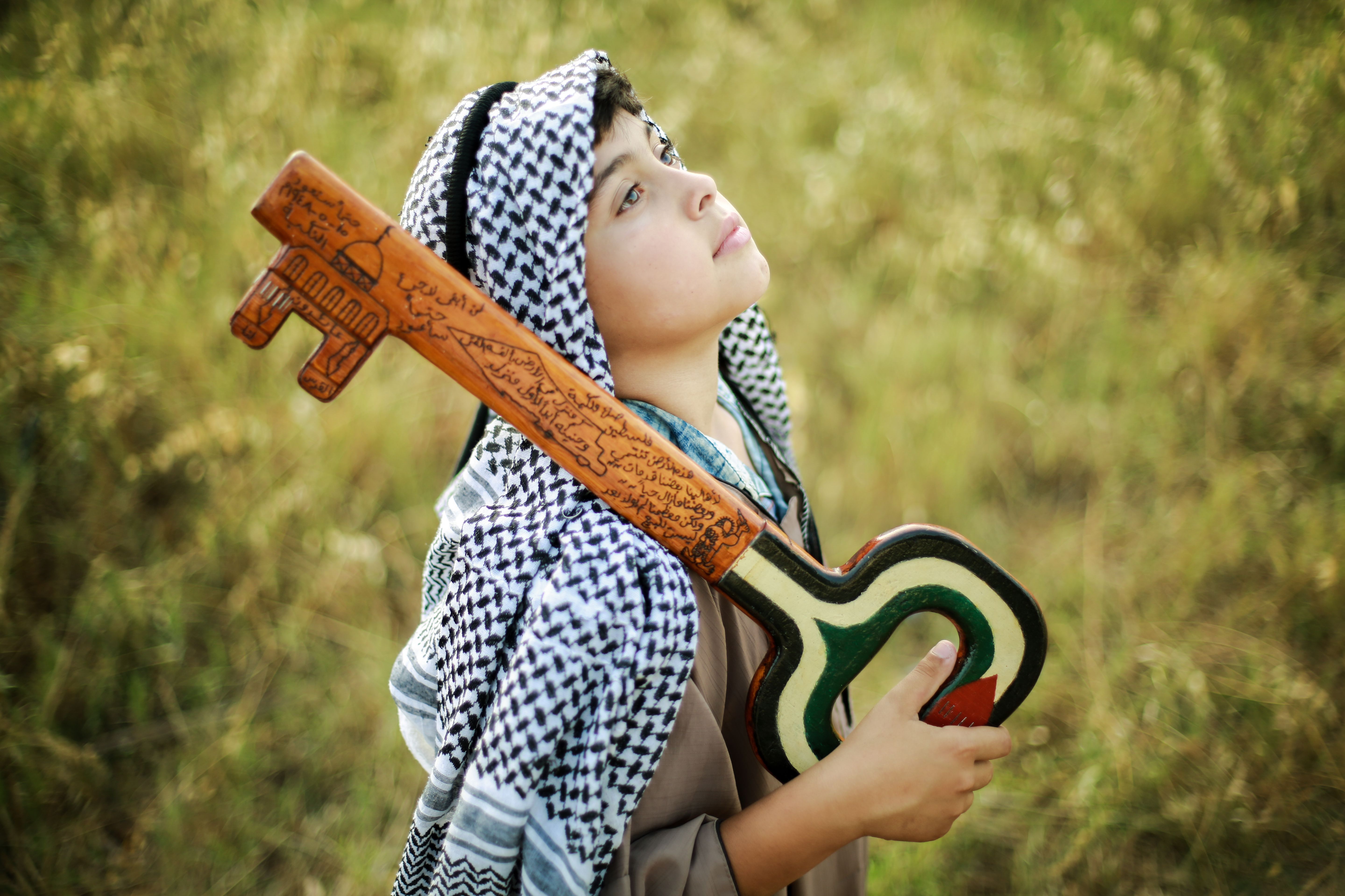 Young Palestinian Child Holding Symbolic Key Outdoors