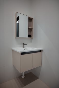 Modern wall-mounted bathroom vanity with integrated sink and mirror cabinet in a minimalist style.