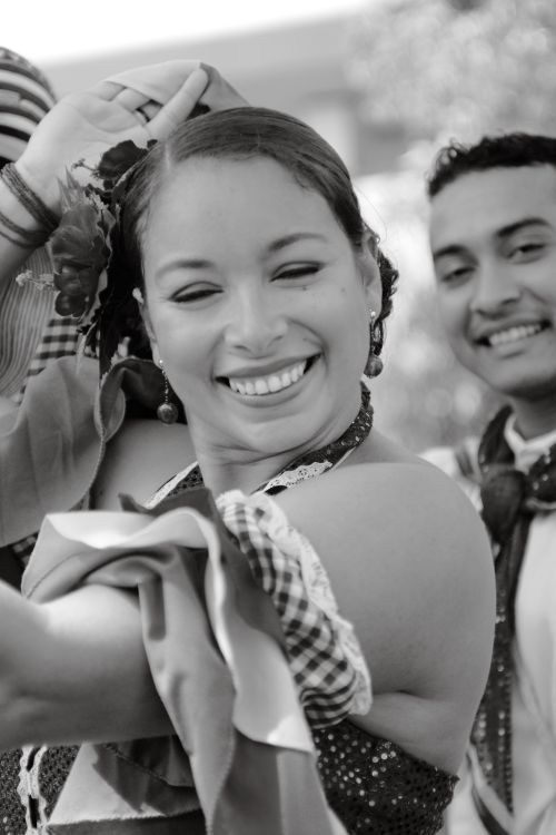 Free A cheerful woman in traditional Latin attire embracing cultural dance. Stock Photo