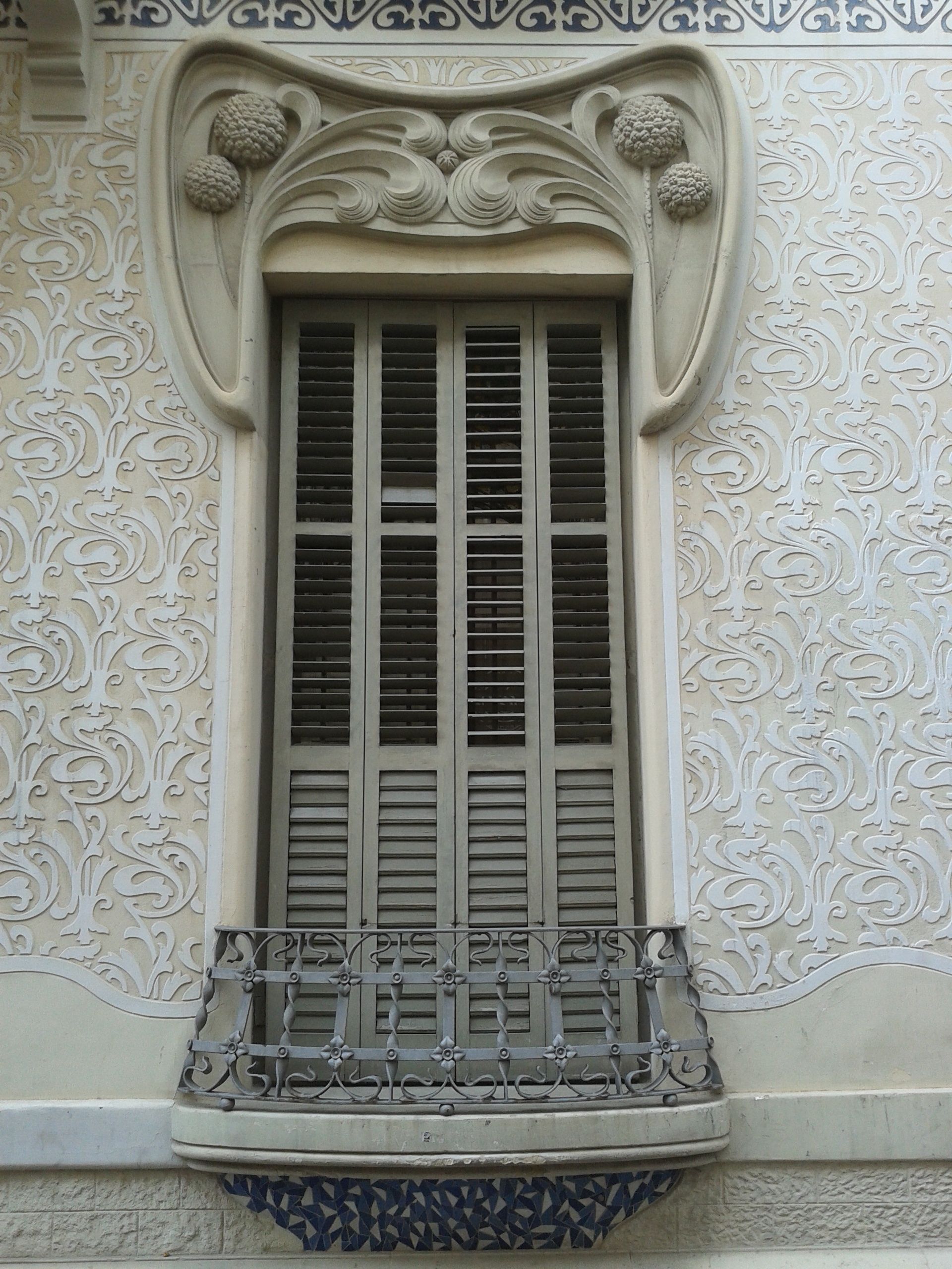 Art Nouveau window with intricate floral patterns and detailed ironwork balcony.. nouveau, window, with