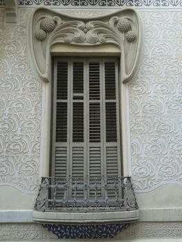 Art Nouveau window with intricate floral patterns and detailed ironwork balcony.. nouveau, window, with