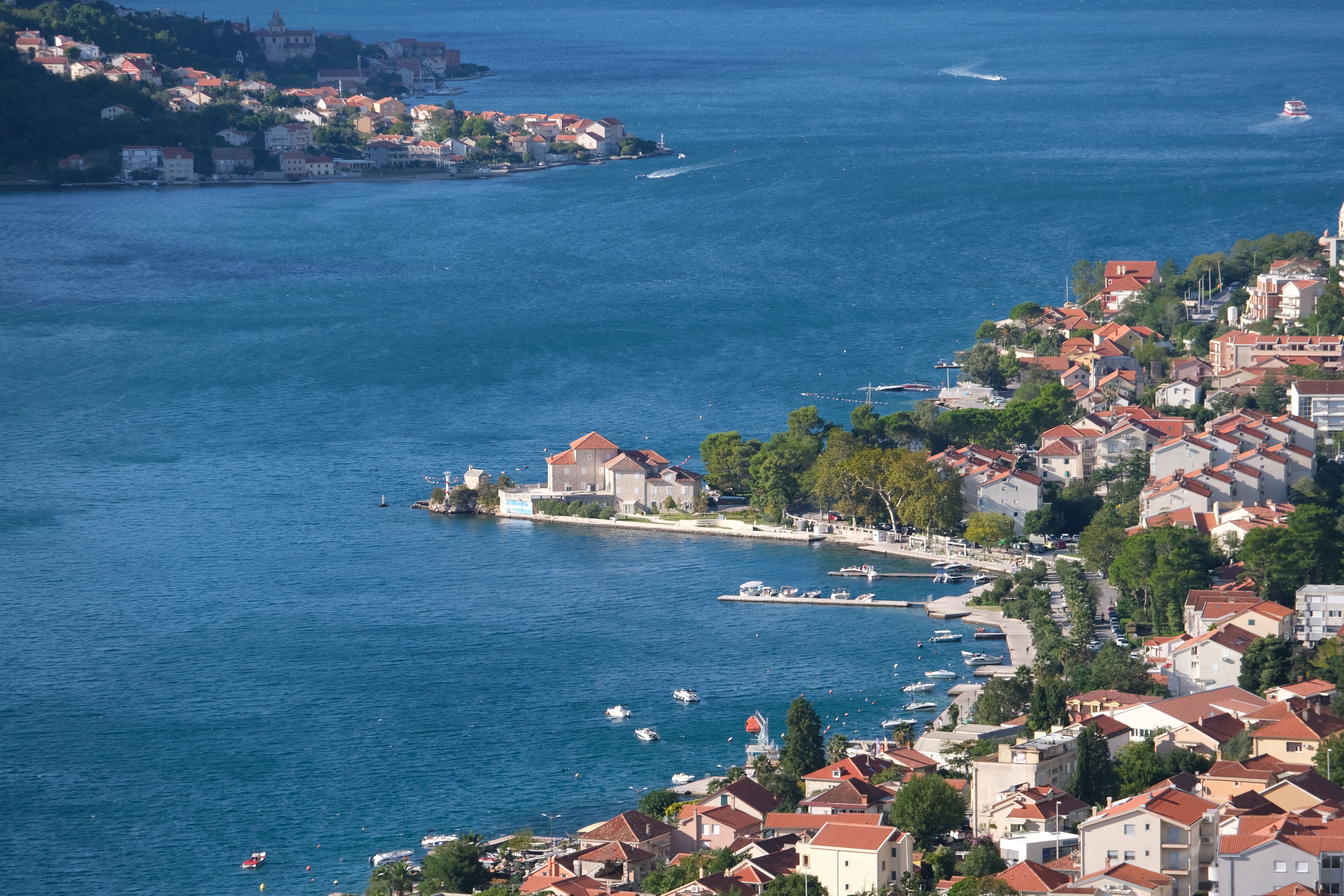 Scenic Aerial View of Coastal Town and Blue Sea · Free Stock Photo