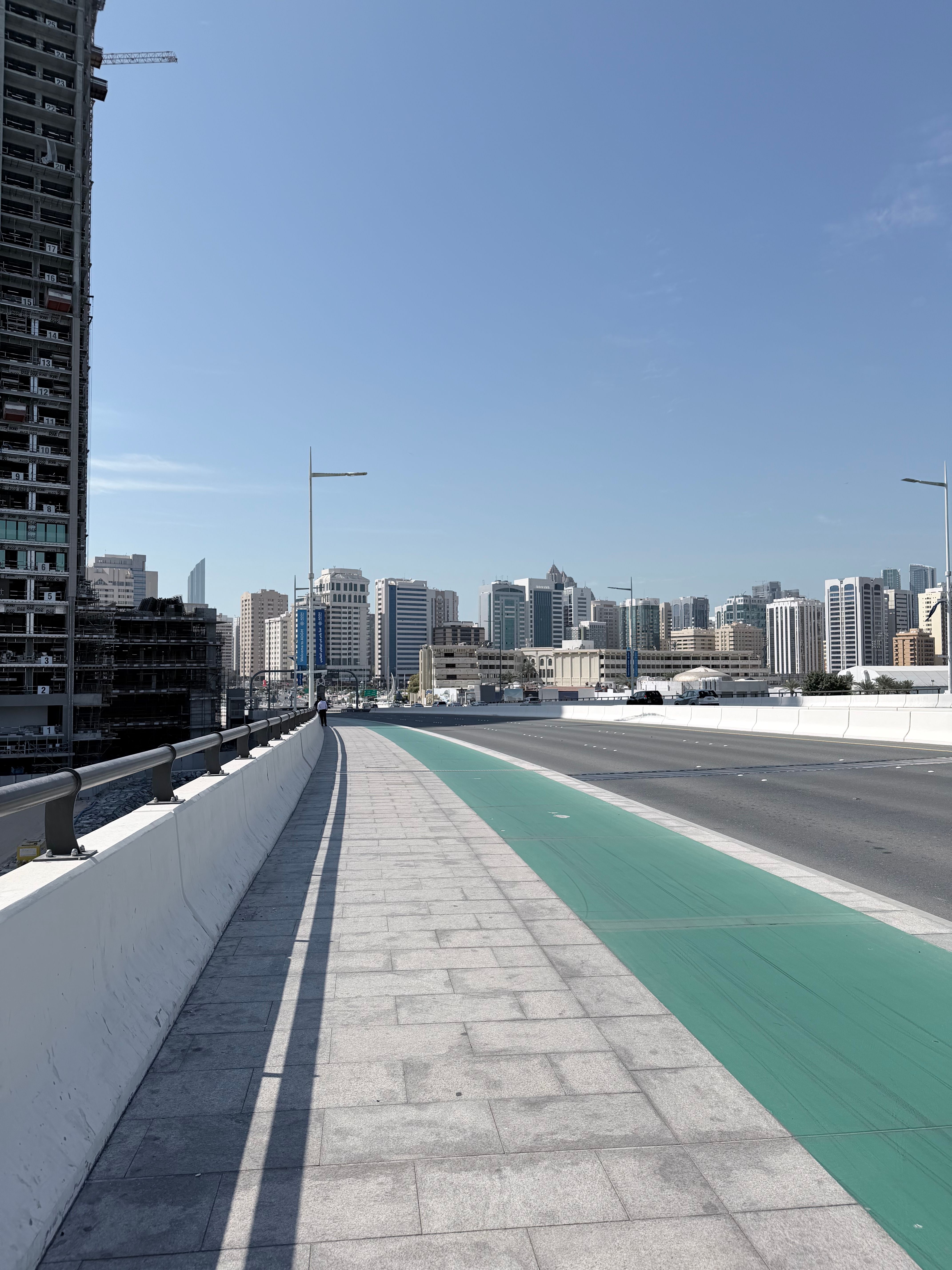View toward Abu Dhabi skyline from a bridge approach near Sheikh Zayed Bridge in Abu Dhabi, United Arab Emirates, useful for atmosphere or map context.