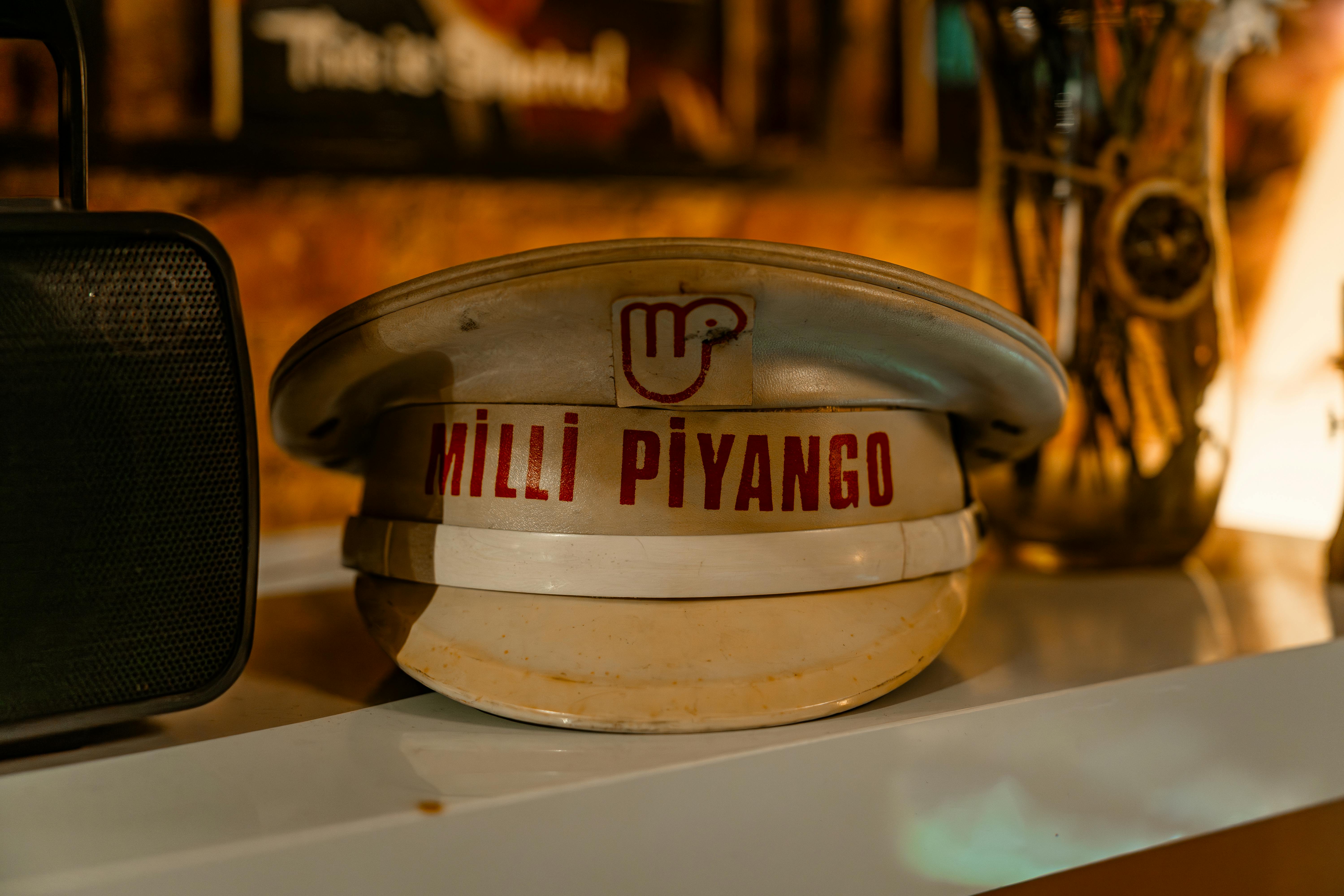 A vintage Milli Piyango hat sits on a shelf amidst retro decor, evoking nostalgia.