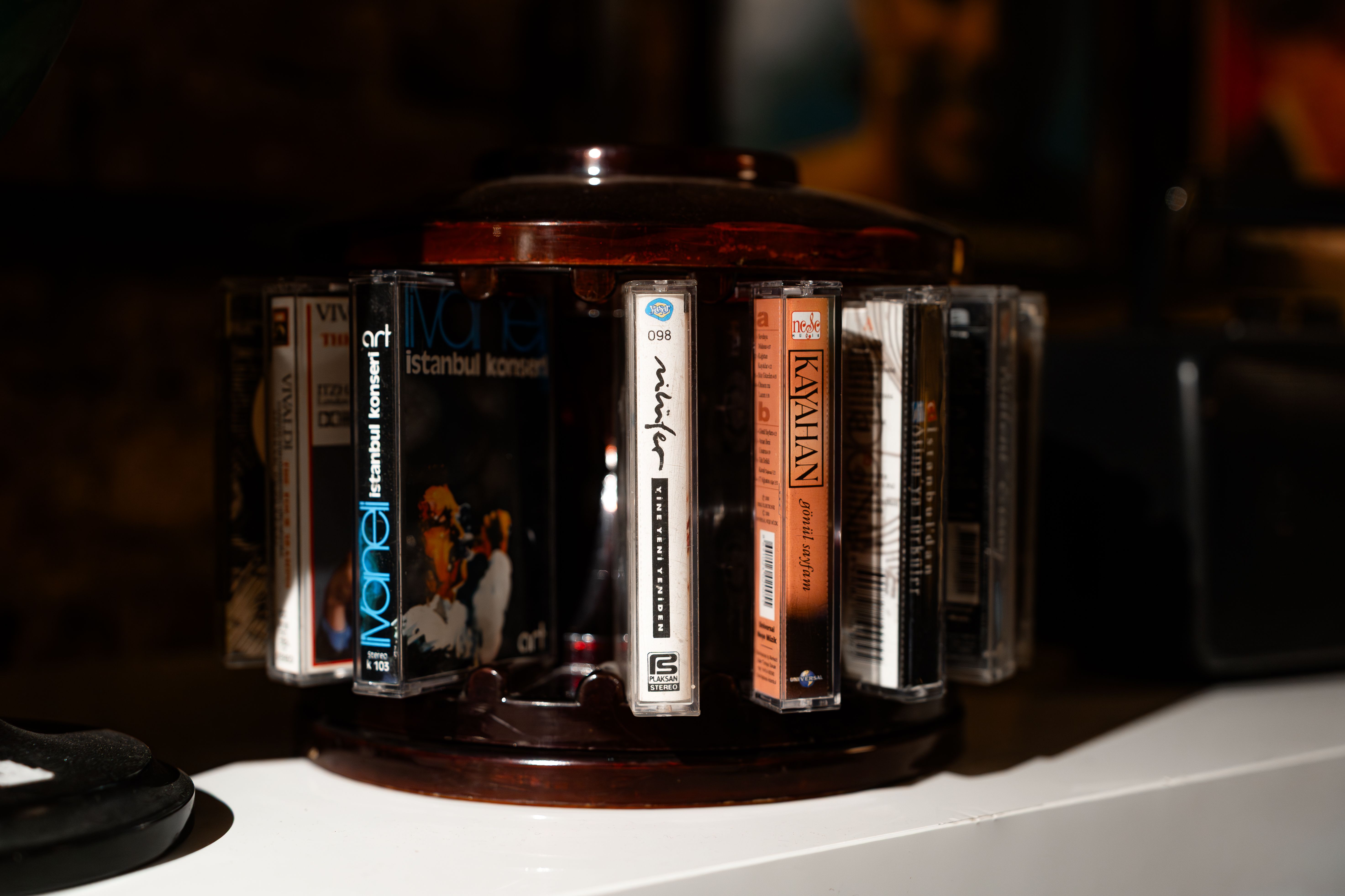 Vintage cassette tapes displayed on a rotating holder, showcasing retro music storage.