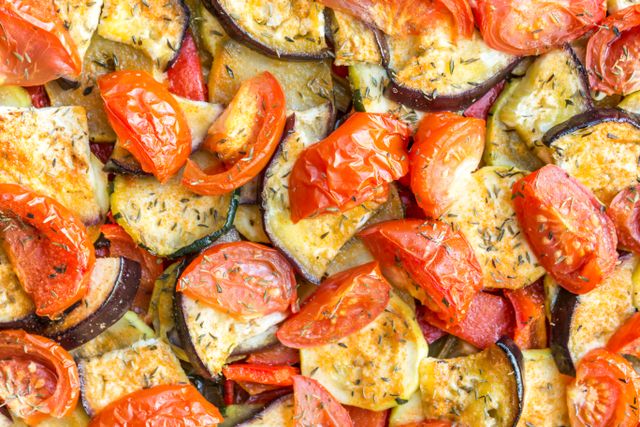 Close-up of a vibrant, fresh ratatouille with tomatoes, eggplants, and spices.