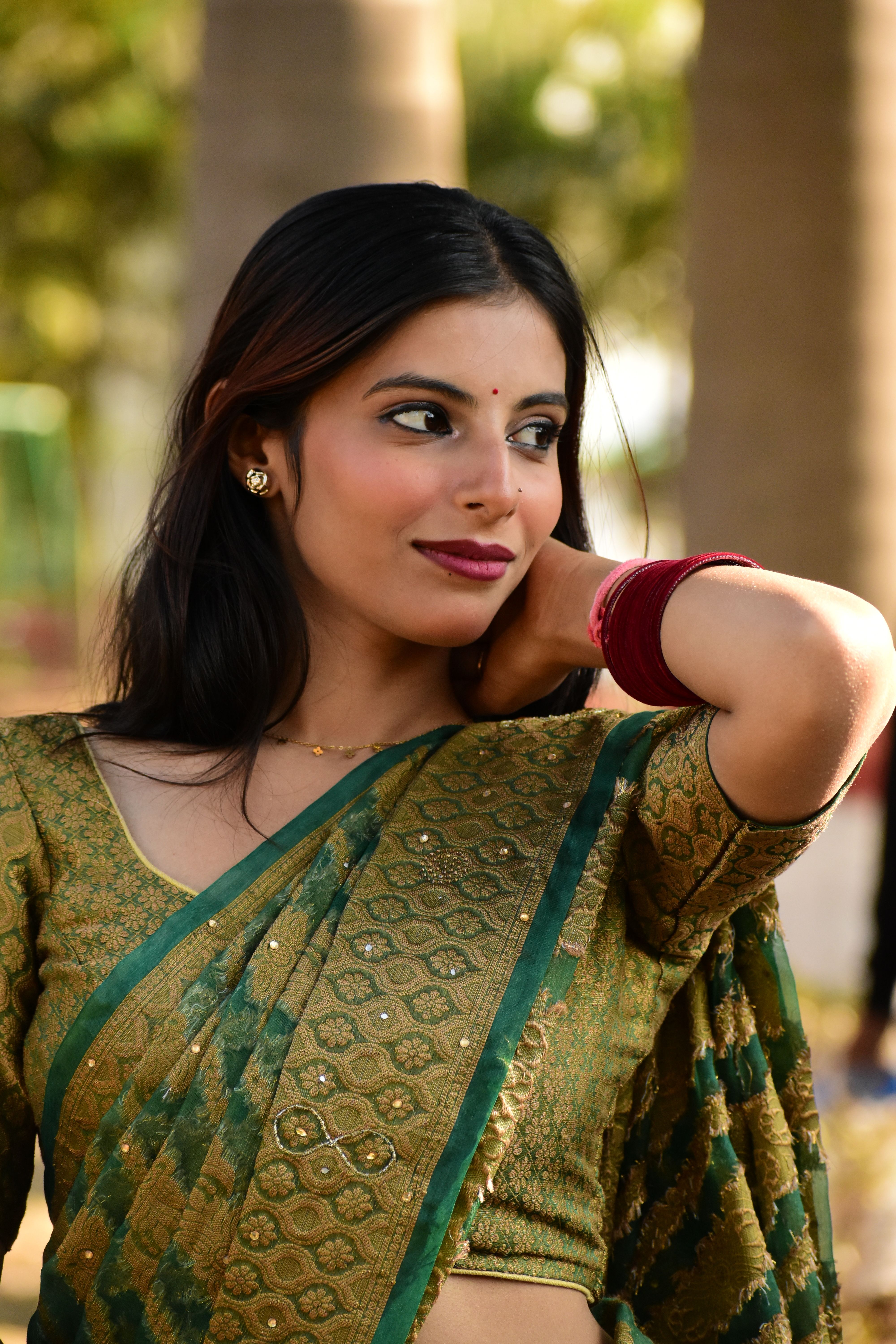 Elegant Woman in Traditional Green Saree Outdoors · Free Stock Photo