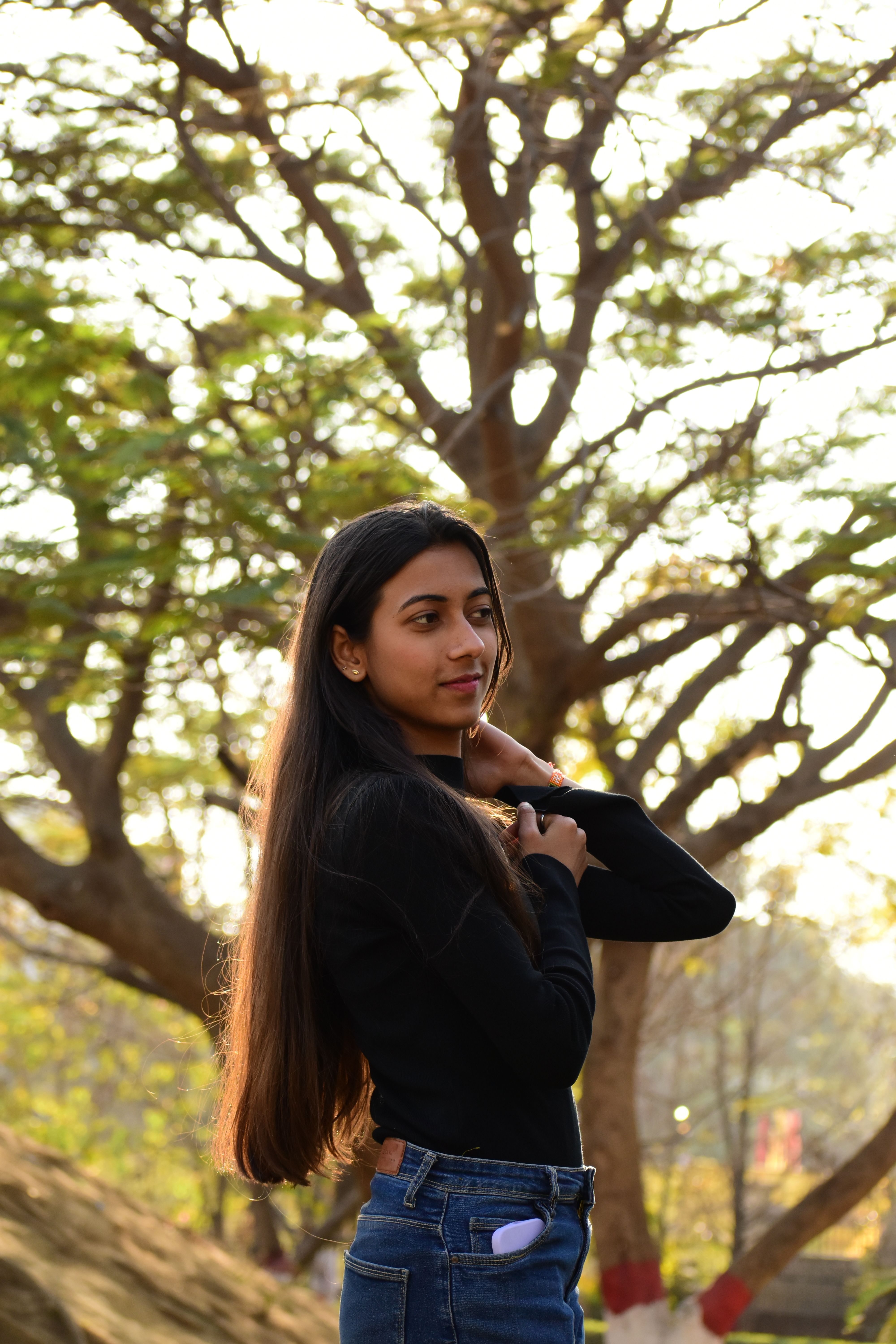 Young Woman Posing Outdoors in Sunlight · Free Stock Photo