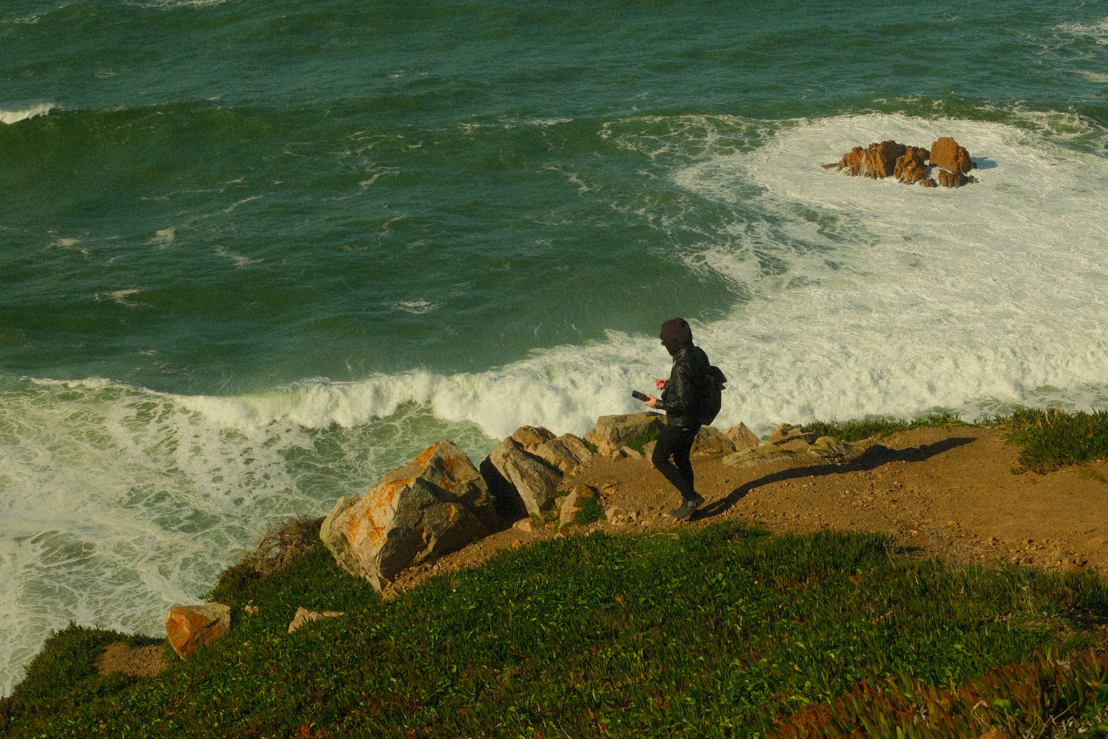Hiker Exploring Ocean Cliffs in Colares, Portugal · Free Stock Photo