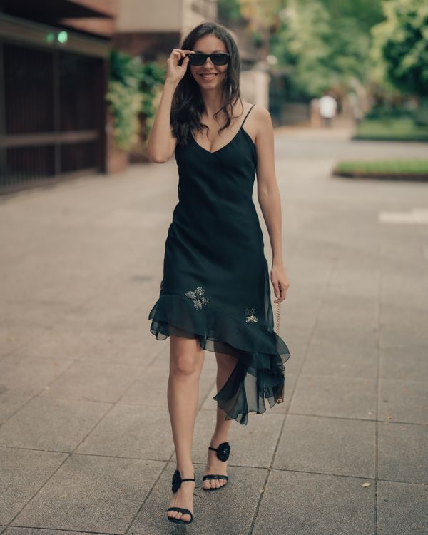 Stylish Woman in Black Dress Walking Outdoors · Free Stock Photo