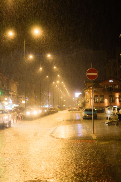 Rainy Night Street Scene with City Lights · Free Stock Photo