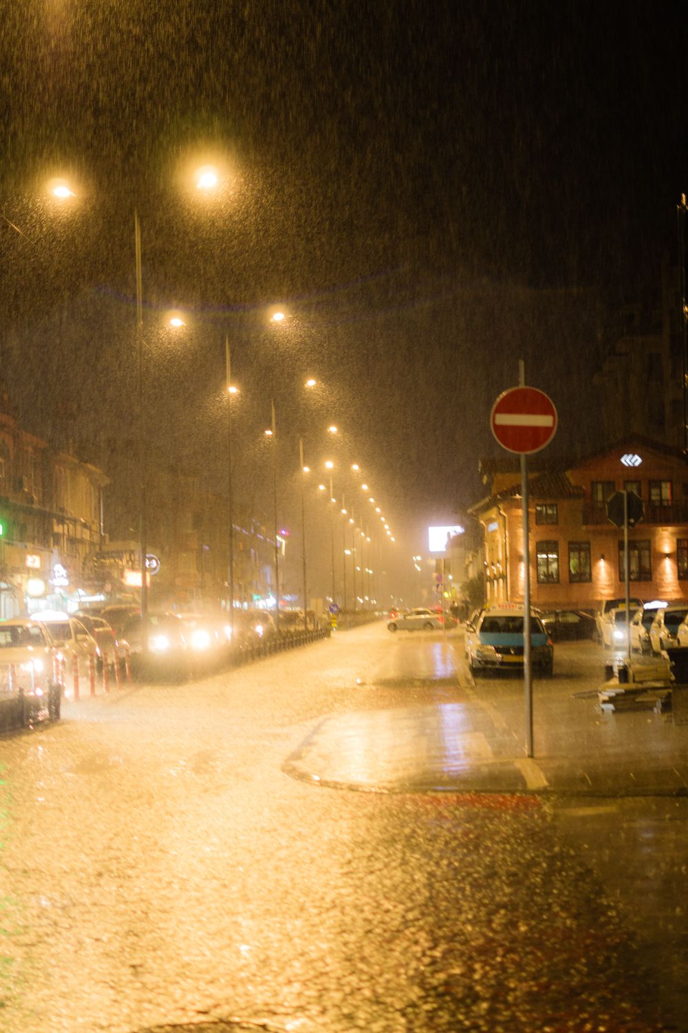 Rainy Night Street Scene with City Lights · Free Stock Photo