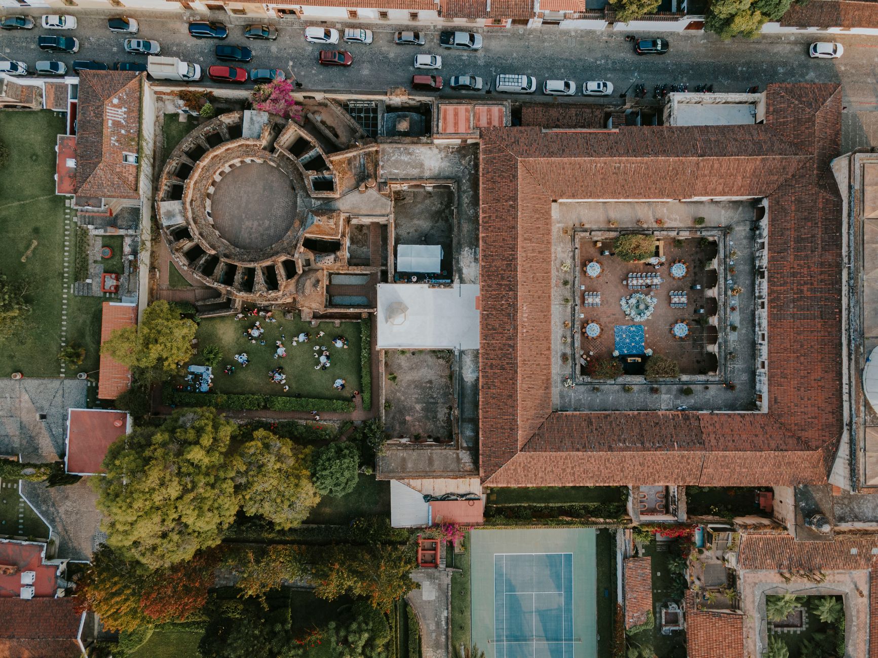 Aerial shot of historic ruins and courtyard in Antigua Guatemala, revealing beautiful architecture and vibrant setting.