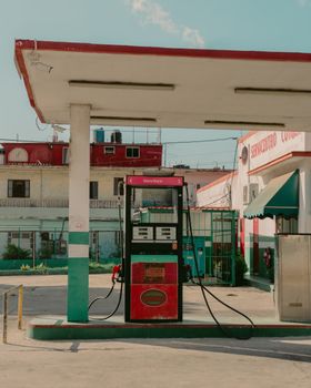 Retro gas station in Cuba with colorful architecture, reflecting a nostalgic urban vibe.
