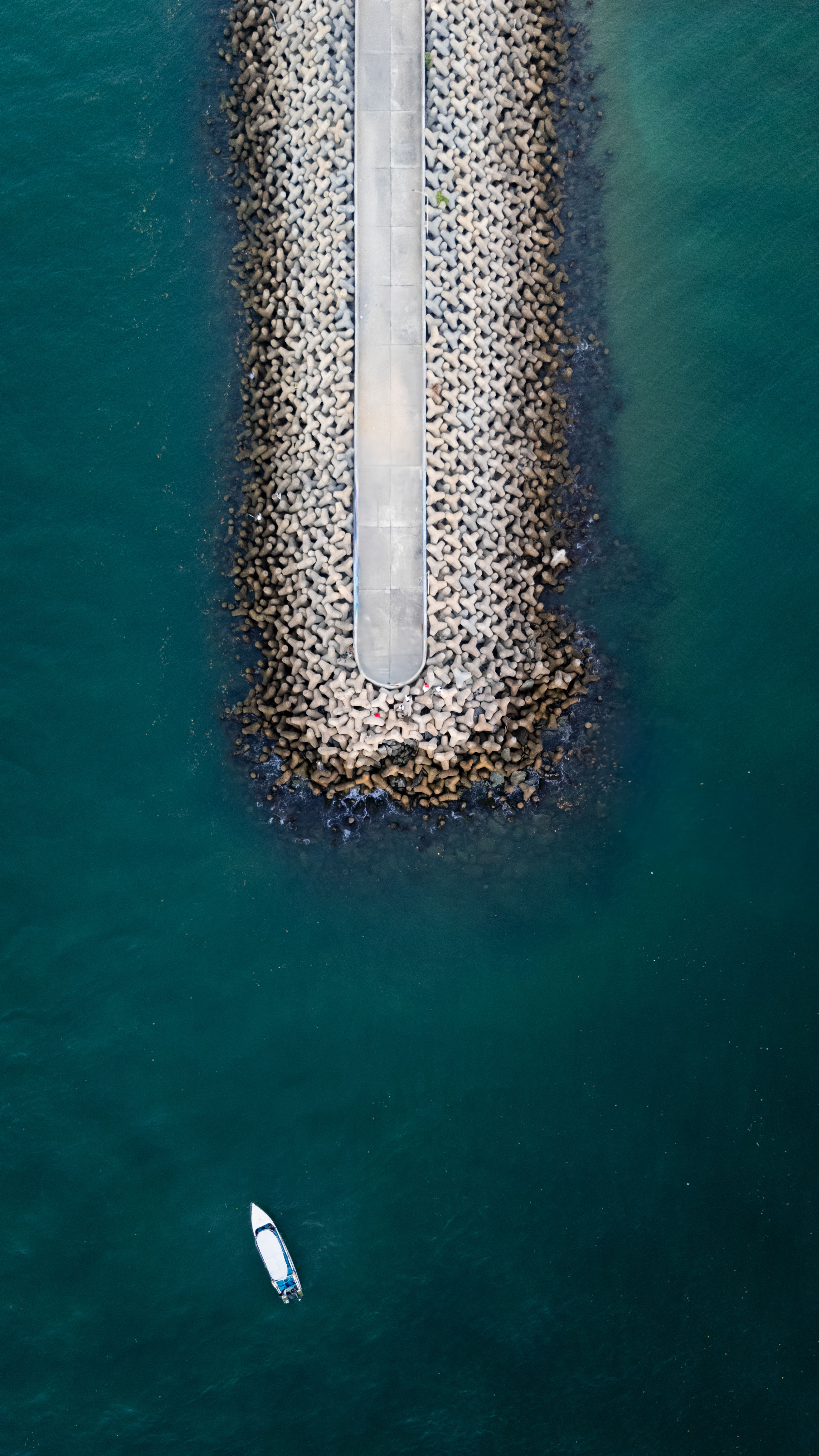 Aerial View of Breakwater and Boat on Blue Sea · Free Stock Photo
