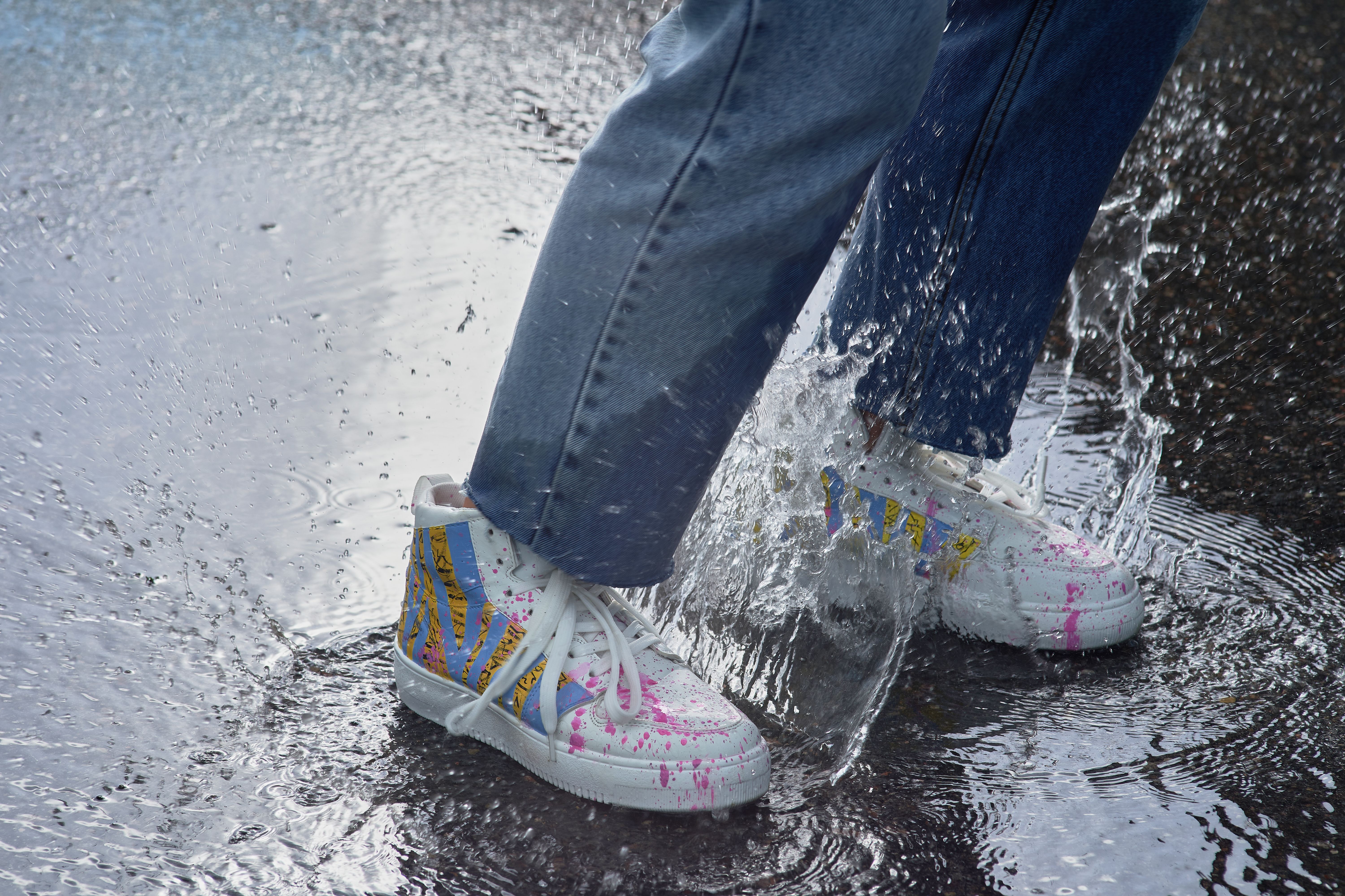 Splash of Colorful Sneakers in a Puddle · Free Stock Photo