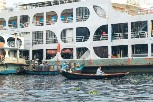 Free Vibrant river scene featuring boats and activity at Sadarghat, Dhaka. Stock Photo