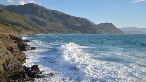 Free Breathtaking view of Ogliastro's rocky coast against the deep blue Mediterranean Sea under a clear sky. Stock Photo