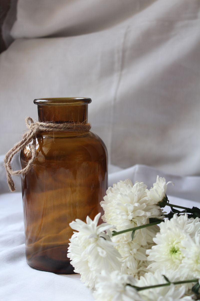 Amber glass vessel with white chrysanthemums by Nutfa Robbani on Pexels