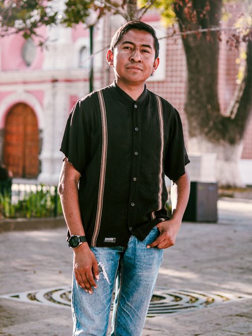 Free Portrait of a young man in a traditional shirt standing confidently outdoors. Stock Photo