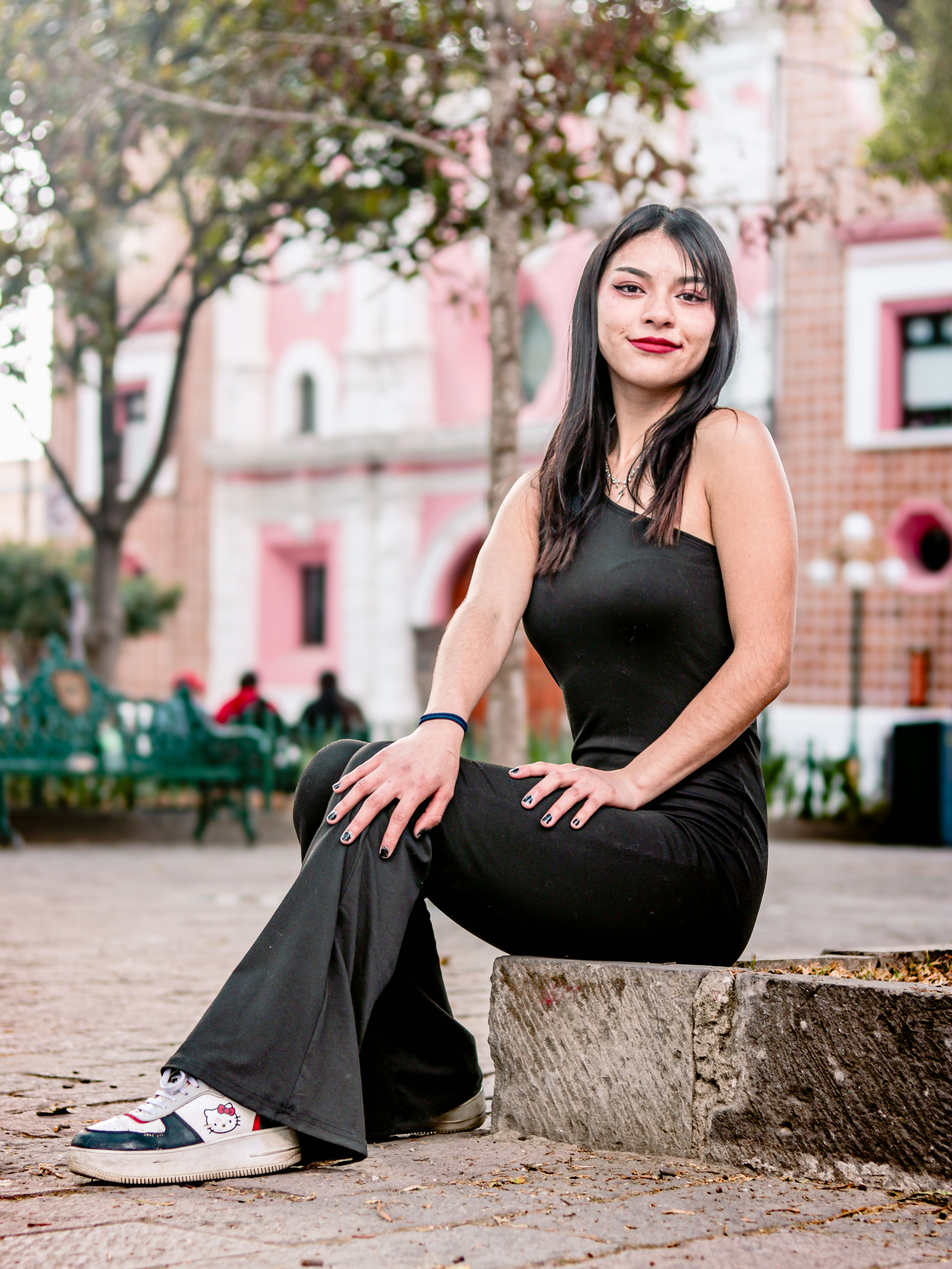 Stylish Woman Posing Outdoors in Urban Park · Free Stock Photo