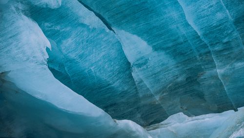 Free Detailed texture of blue glacier ice with smooth, layered patterns. Stock Photo