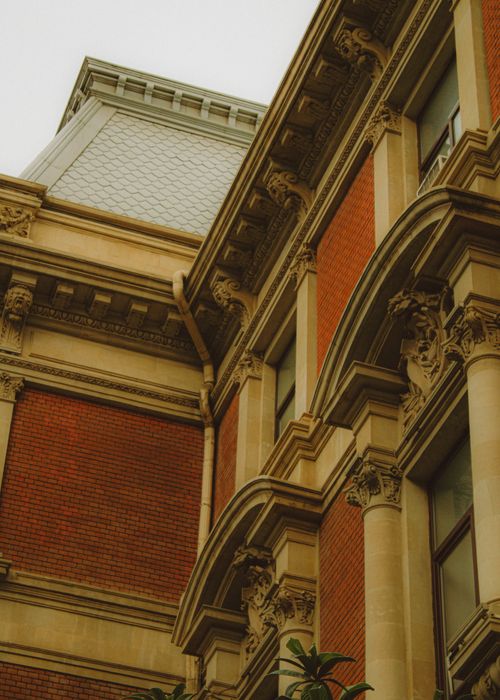 Free Close-up of a historic building in Baku with intricate architectural details and red brick facade. Stock Photo