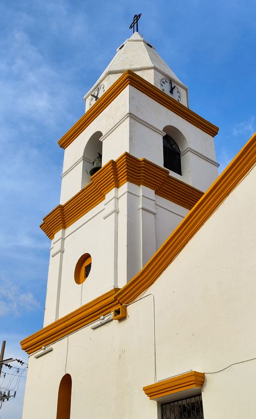 Free View of a historic church tower in Valledupar, showcasing colonial architecture against a clear blue sky. Stock Photo