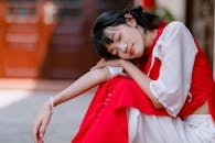 Young Woman Resting Outdoors in Red Outfit