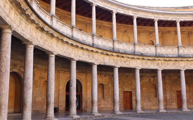 Photo: José Manuel on Pexels Explore the Renaissance architecture of the circular courtyard at Charles V Palace in Granada, Spain.
