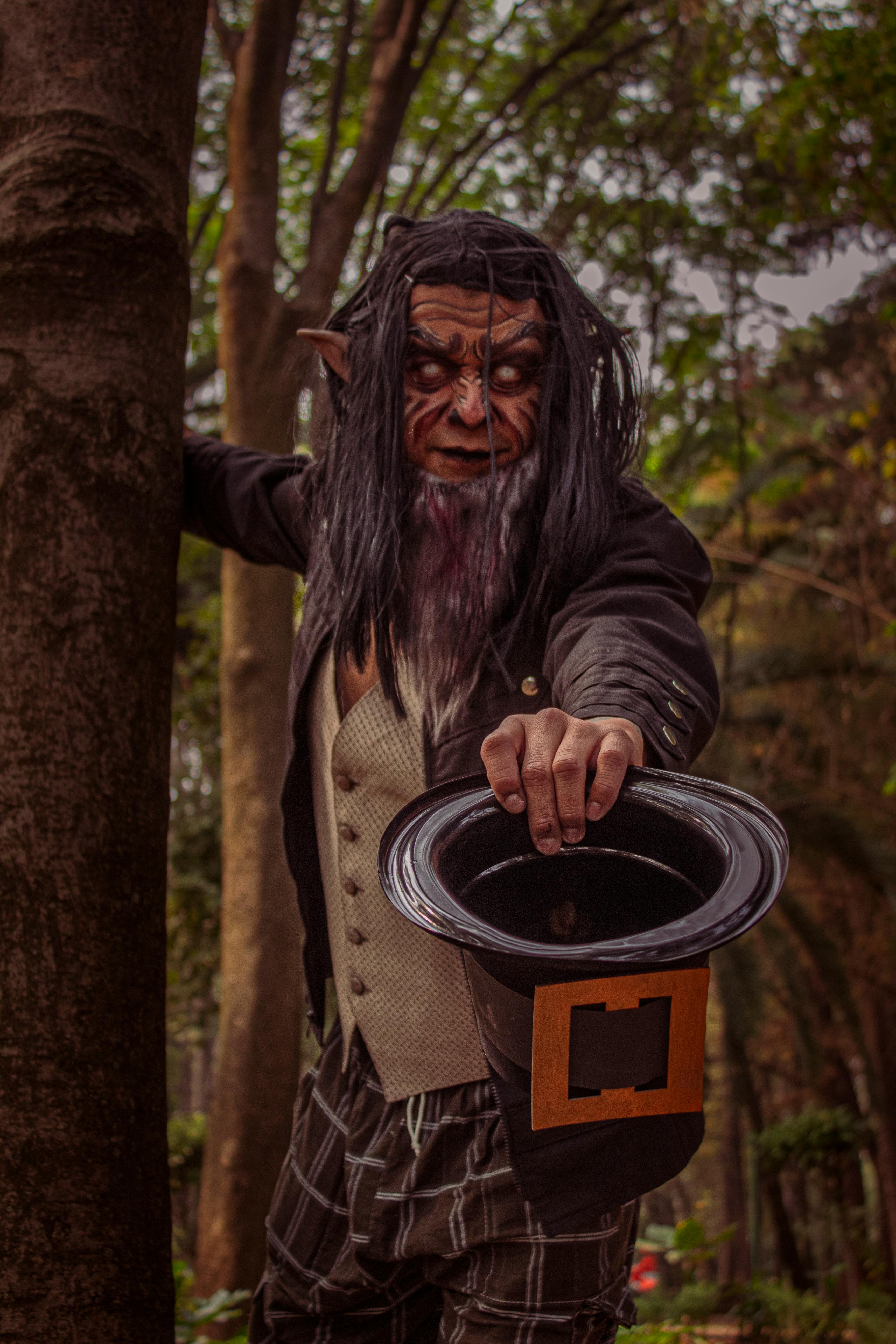 Fantasy-themed portrait of an elf character in mystical forest with detailed makeup.