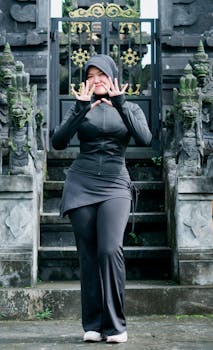Asian woman in black outfit posing confidently at a traditional temple in Banten, Indonesia.