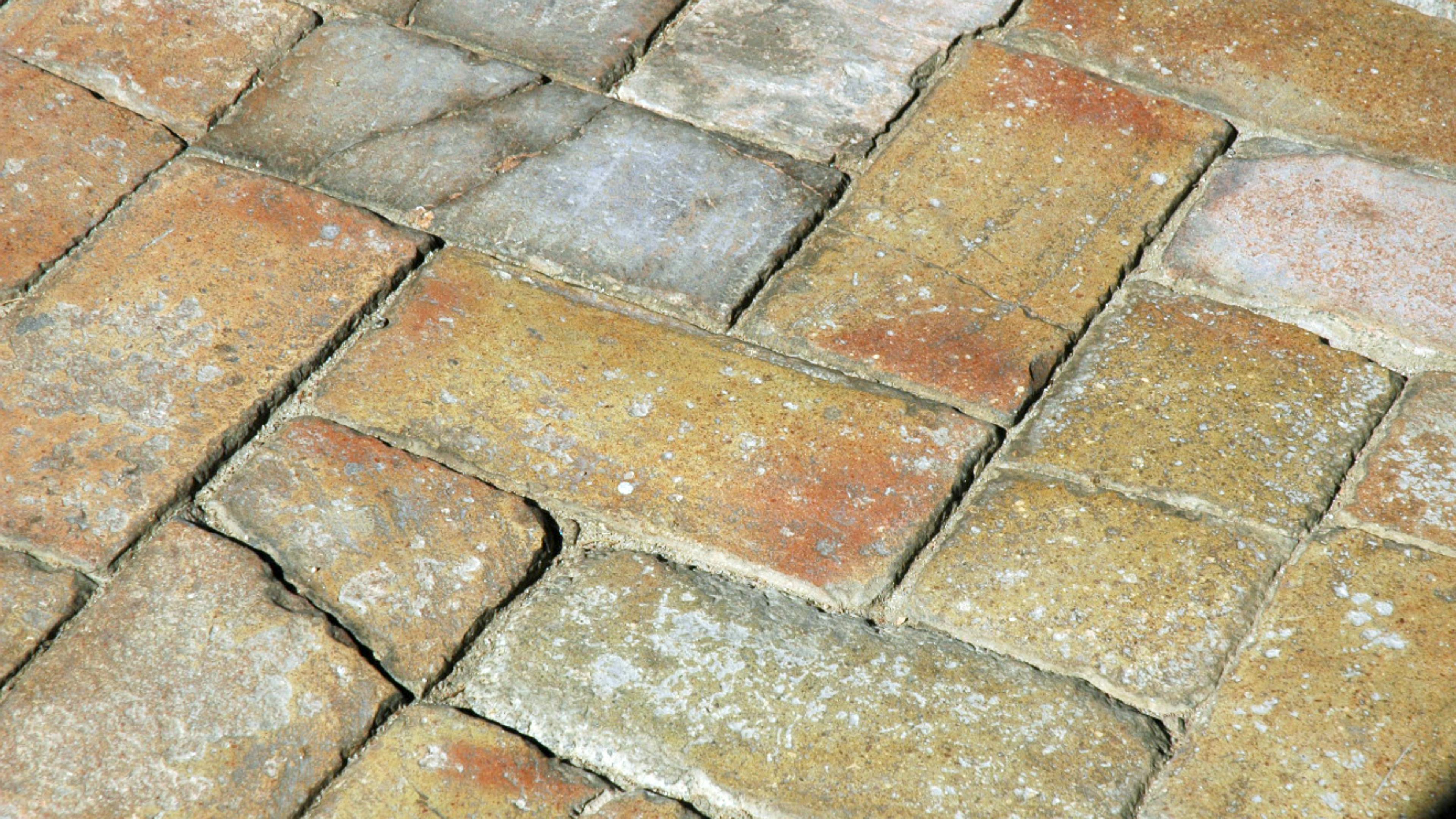 Free Detailed view of aged cobblestone pavement showing texture and color variations. Stock Photo