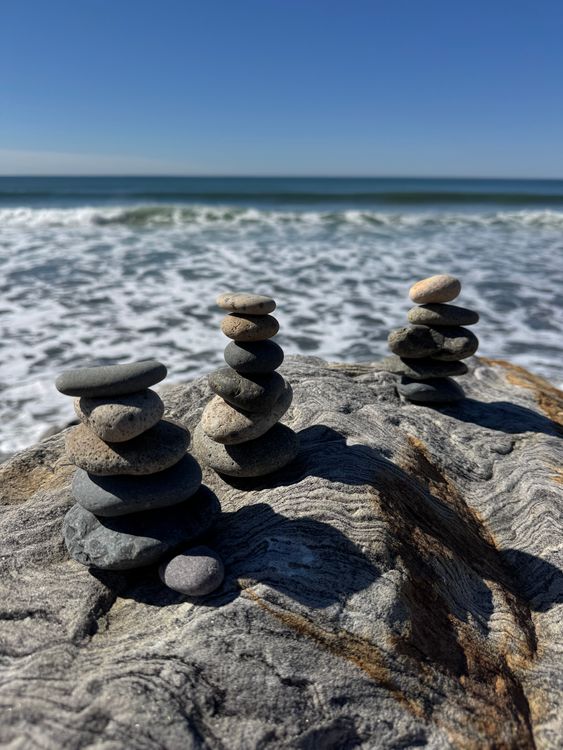 Balanced Beach Stones with Ocean Background · Free Stock Photo