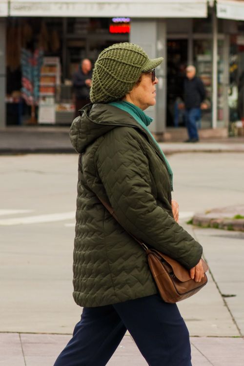 Woman walking with winter attire in city · Free Stock Photo