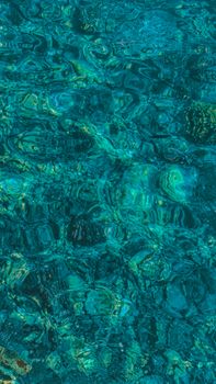 Crystal clear turquoise water in Egypt, showcasing the vibrant sea pattern and sunlight reflections.