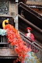 Woman in Traditional Dress by Decorated Staircase