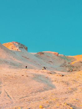 Explore the mesmerizing desert of Egypt with hikers under a clear blue sky.