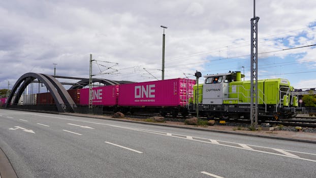 Freight train crossing a bridge in Hamburg, Germany, transporting goods.