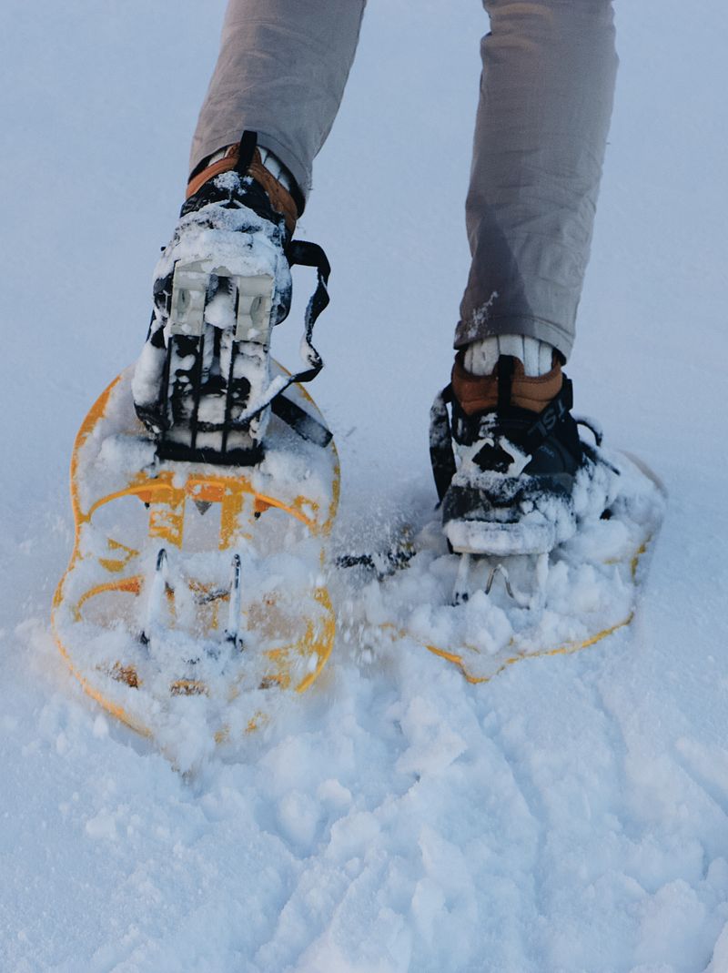 Hiker in snowshoes on snowy mountain
