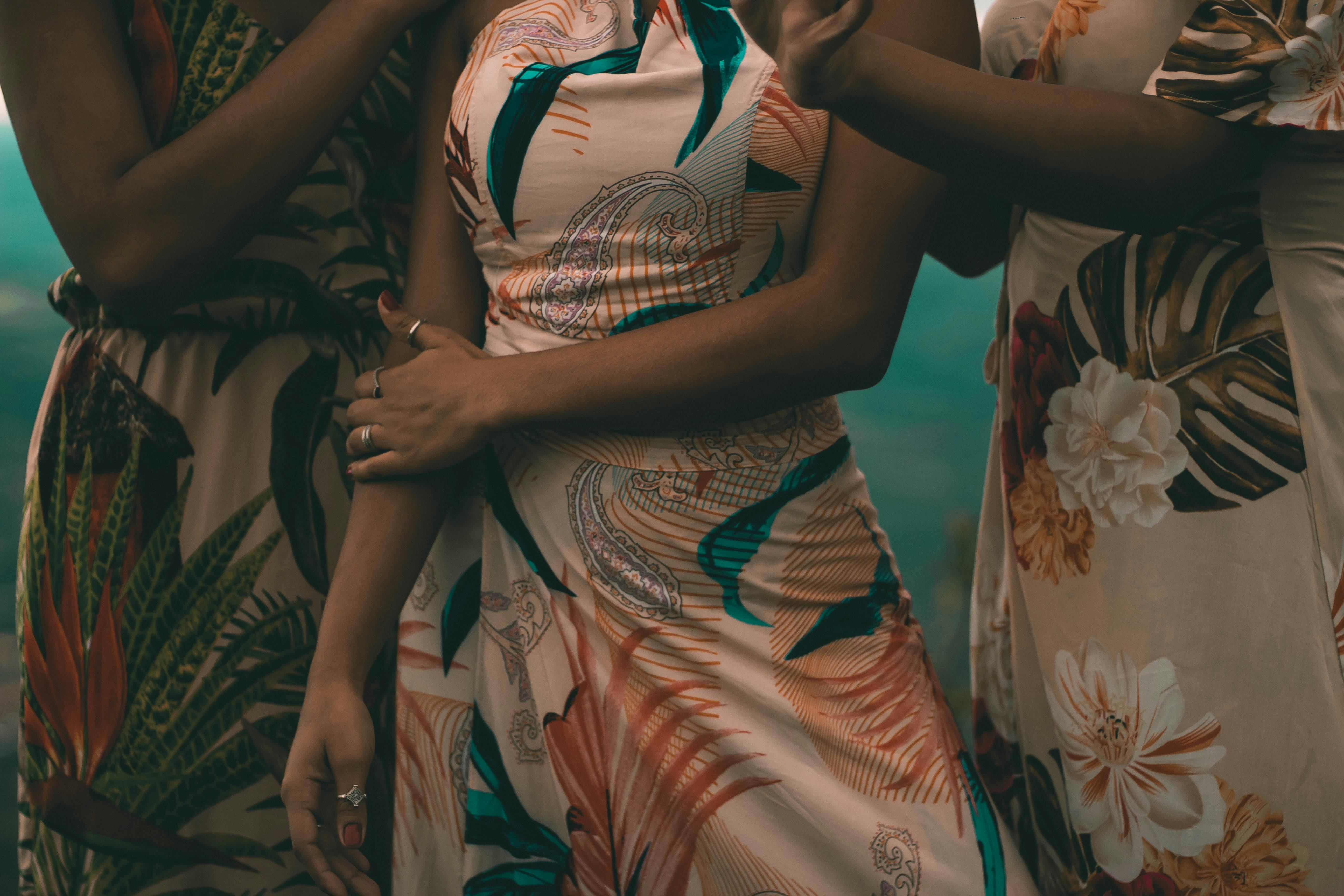 Free Women in Orange and White Floral Dresses Stock Photo