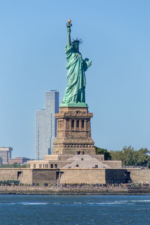 Free Iconic Statue of Liberty with clear blue sky, symbolizing freedom in New York City. Stock Photo