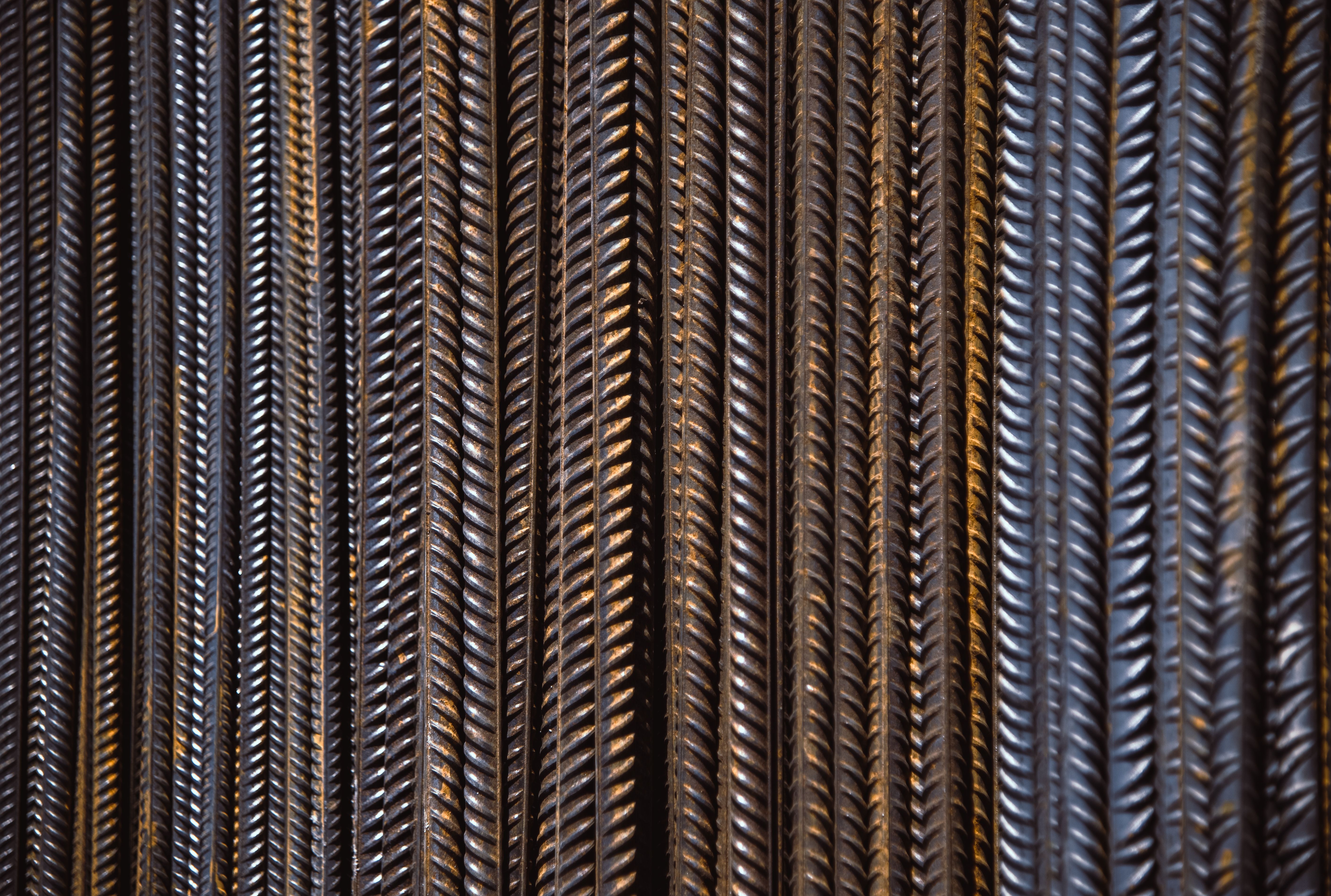 Detailed view of vertically aligned textured rebar showing intricate patterns.