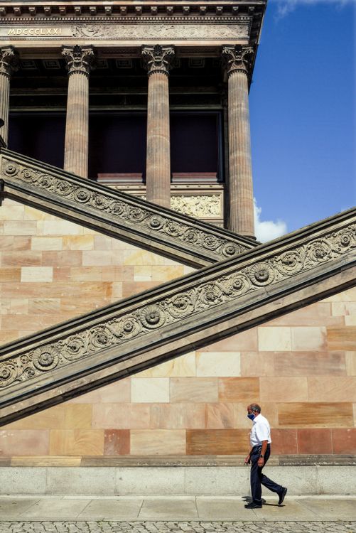 Man Walking by Historic Architectural Structure · Free Stock Photo