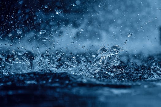 A vivid close-up of water droplets splashing, captured with dynamic detail and motion.
