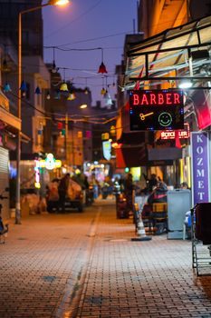 A lively night street view featuring bright neon signs and festive decorations.