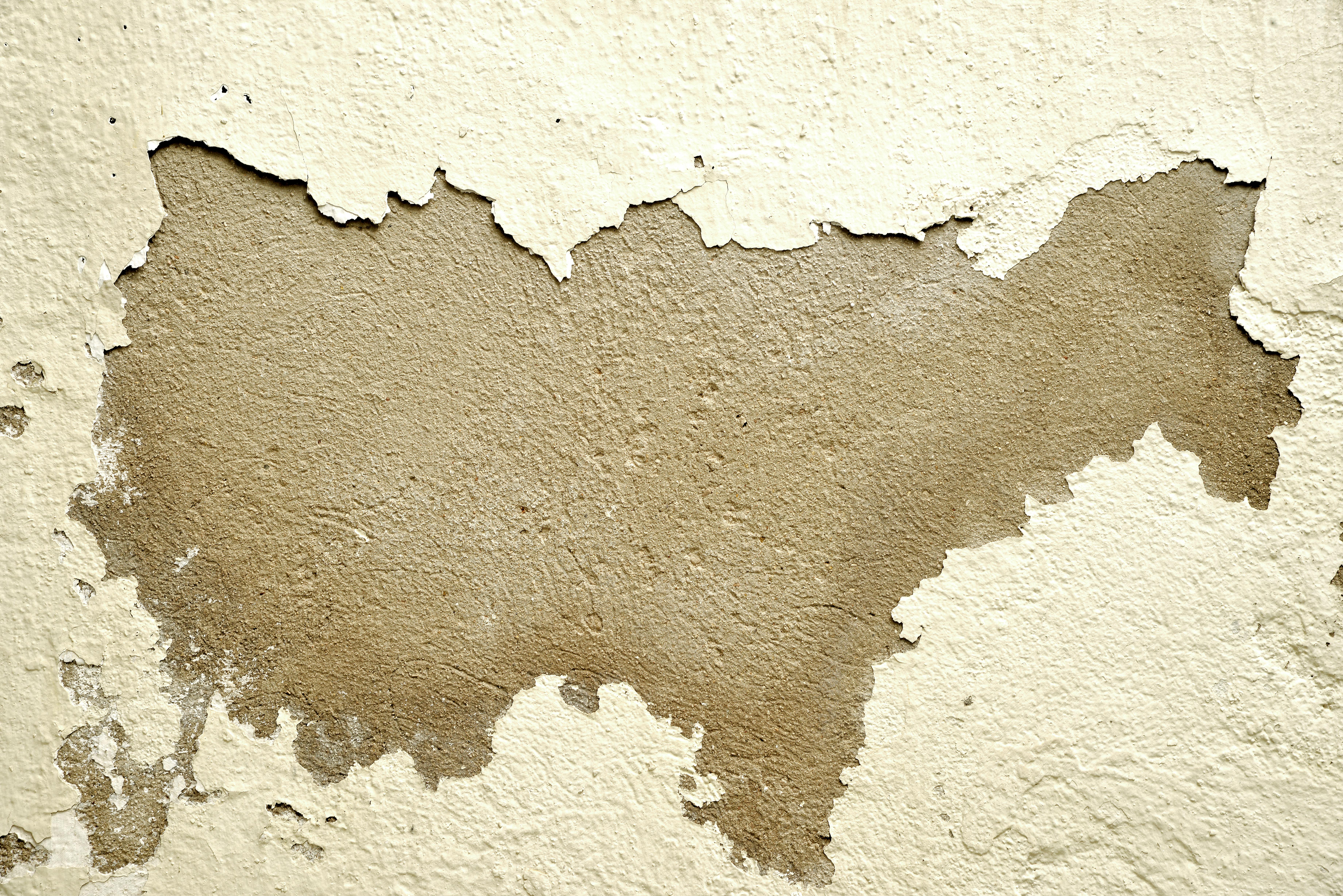 免费 特写镜头拍摄一面墙，剥落的油漆露出下面粗糙的纹理。 素材图片