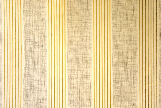 Vintage wallpaper with vertical stripes and textured patterns in beige and gold tones.